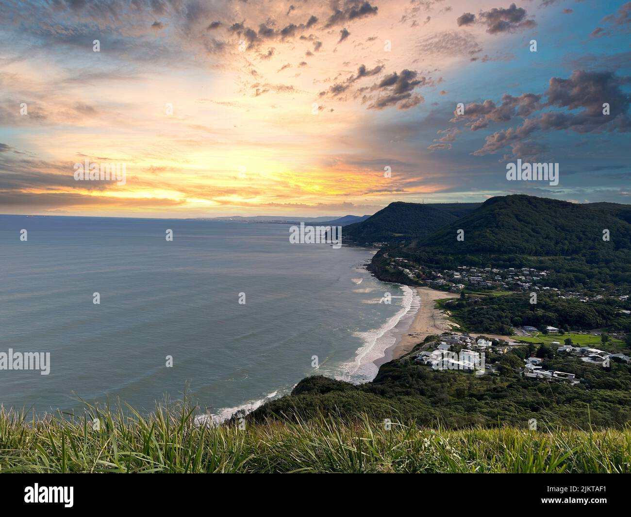 A scenic sunset view of the coastline of Stanwell Park from Bald Hill Lookout, New South Wales, Australia Stock Photo
