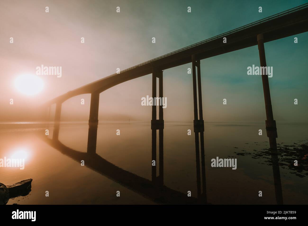 A bridge over the lake at a colorful sunset background Stock Photo - Alamy
