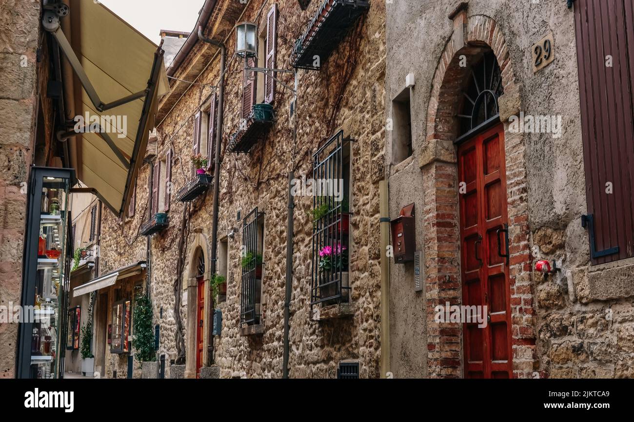The stone facade of an old building in the street in San Marino Stock Photo