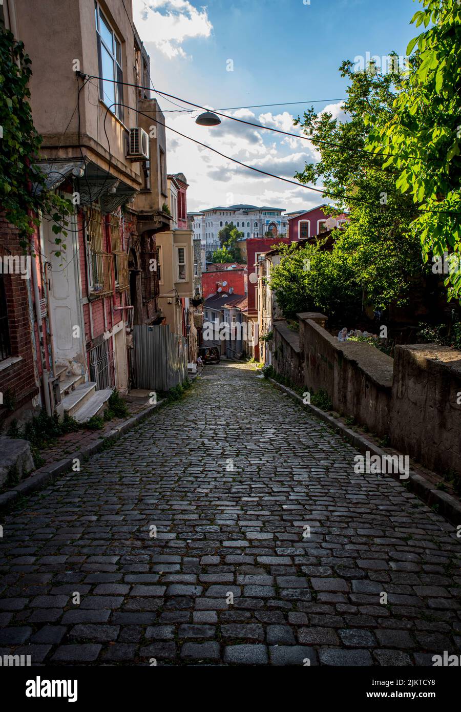A vertical shot of a narrow street lined with stone in Istanbul Stock Photo