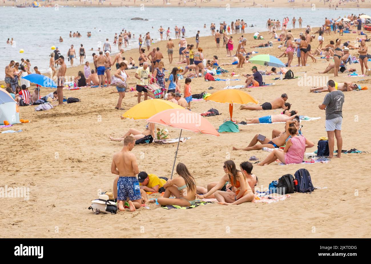 Las Palmas, Gran Canaria, Canary Islands, Spain. 3rd August, 2022. Tourists, many from the UK, bask on the city beach in Las Palmas on Gran Canaria; a popular summer holiday destination for many British holidaymakers. Credit: Alan Dawson/ Alamy Live News. Stock Photo