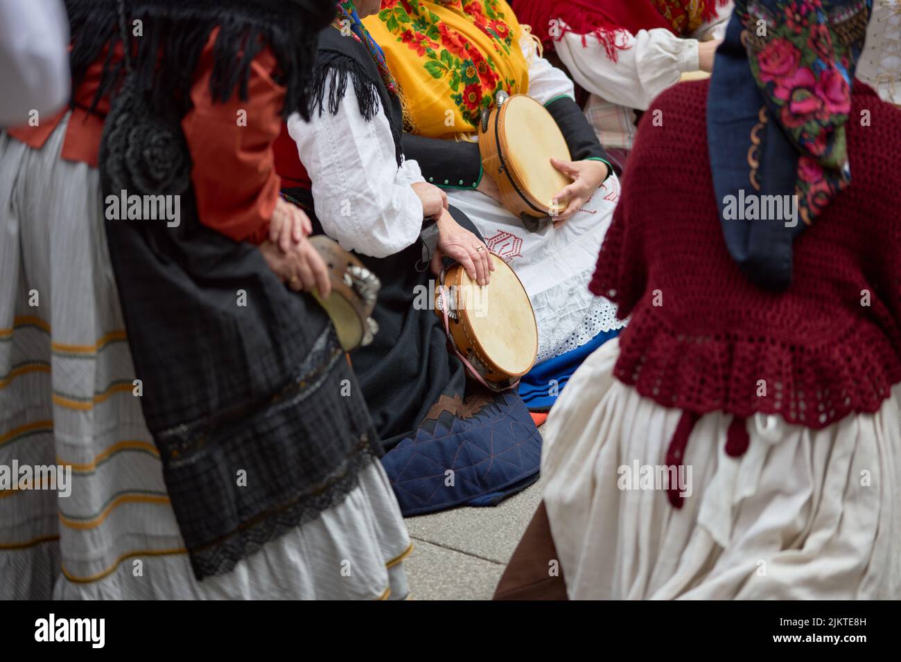 Women In Period Costumes Playing Tambourines At A Popular Festival In women-in-period-costumes-playing-tambourines-at-a-popular-festival-in