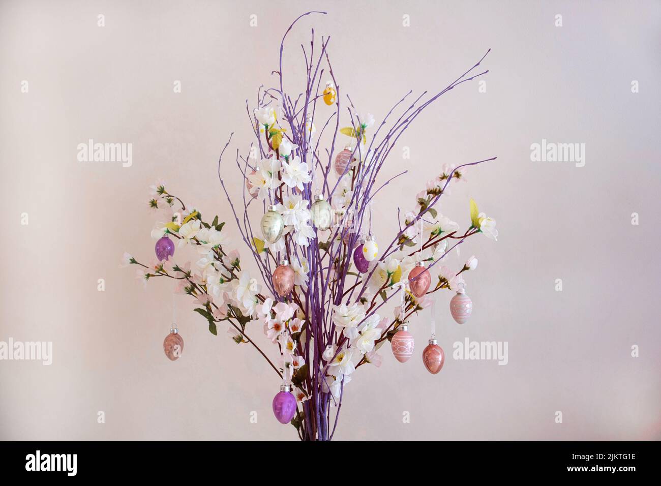 Branches with Easter decorations on a cloudy, uneven background Stock Photo