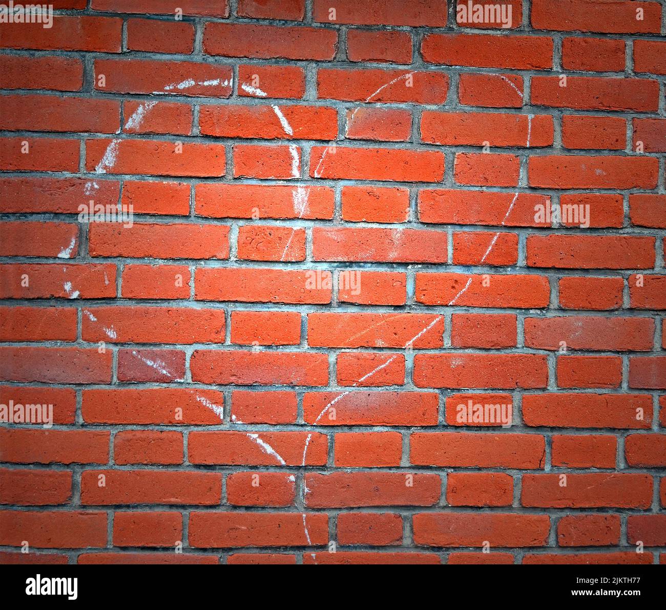 heart sign drawn by white chalk on red brick wall, love diversity Stock Photo