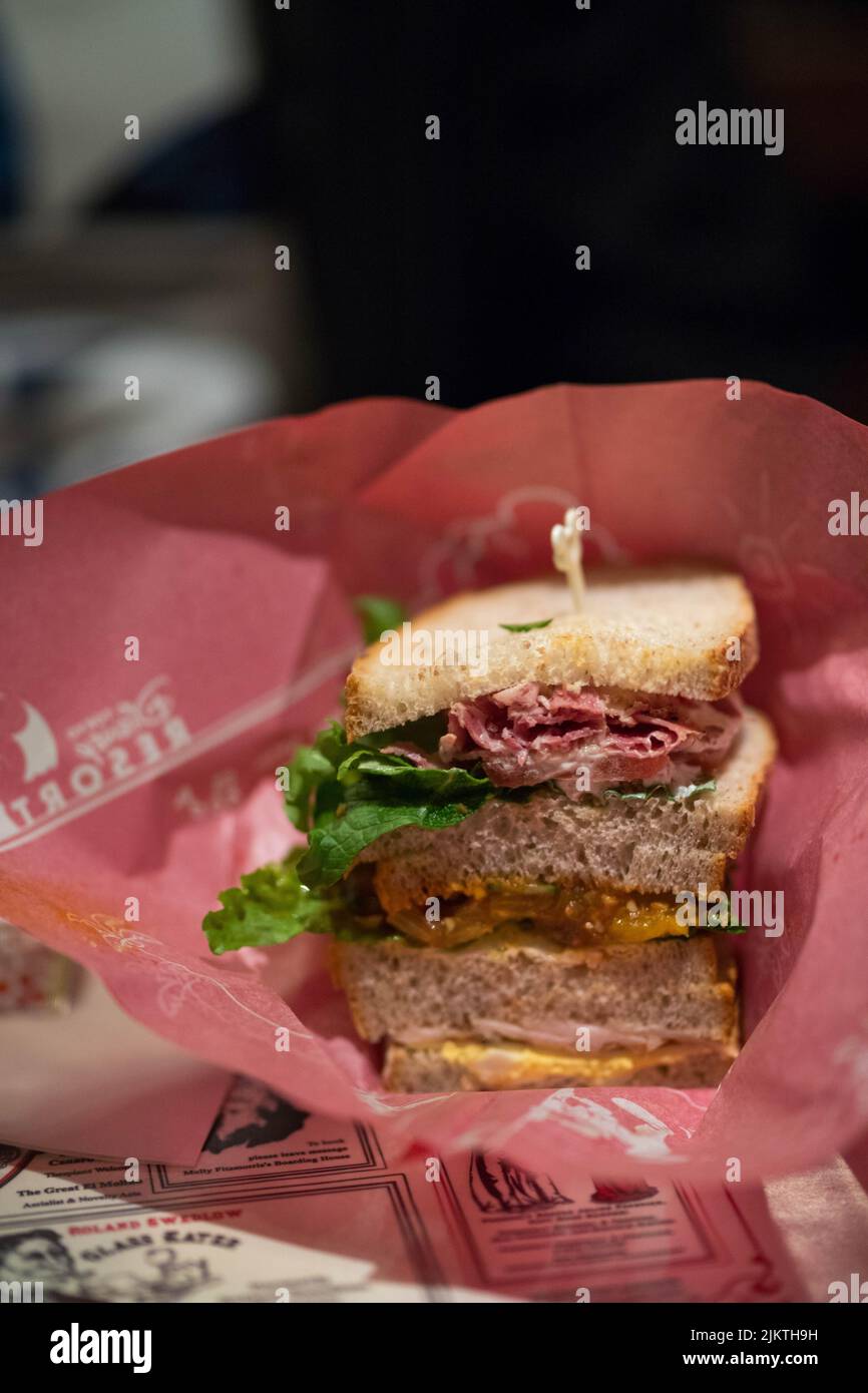 a vertical shot of sandwitch in red paper Stock Photo