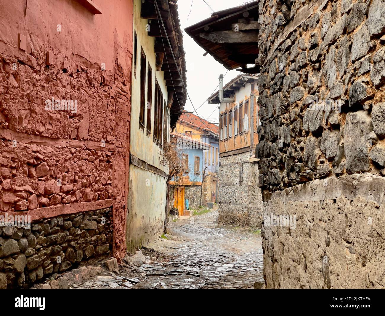 A narrow stone alley through historic buildings in Cumalikizik, Bursa, Turkey Stock Photo