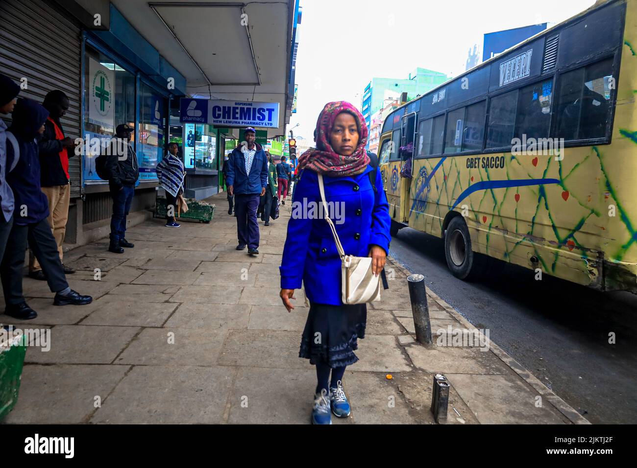 Pedestrians walk past the busy streets of Nairobi's Central business District in Kenya. Most Kenyan schools were on August 2, 2022 closed for a short Stock Photo