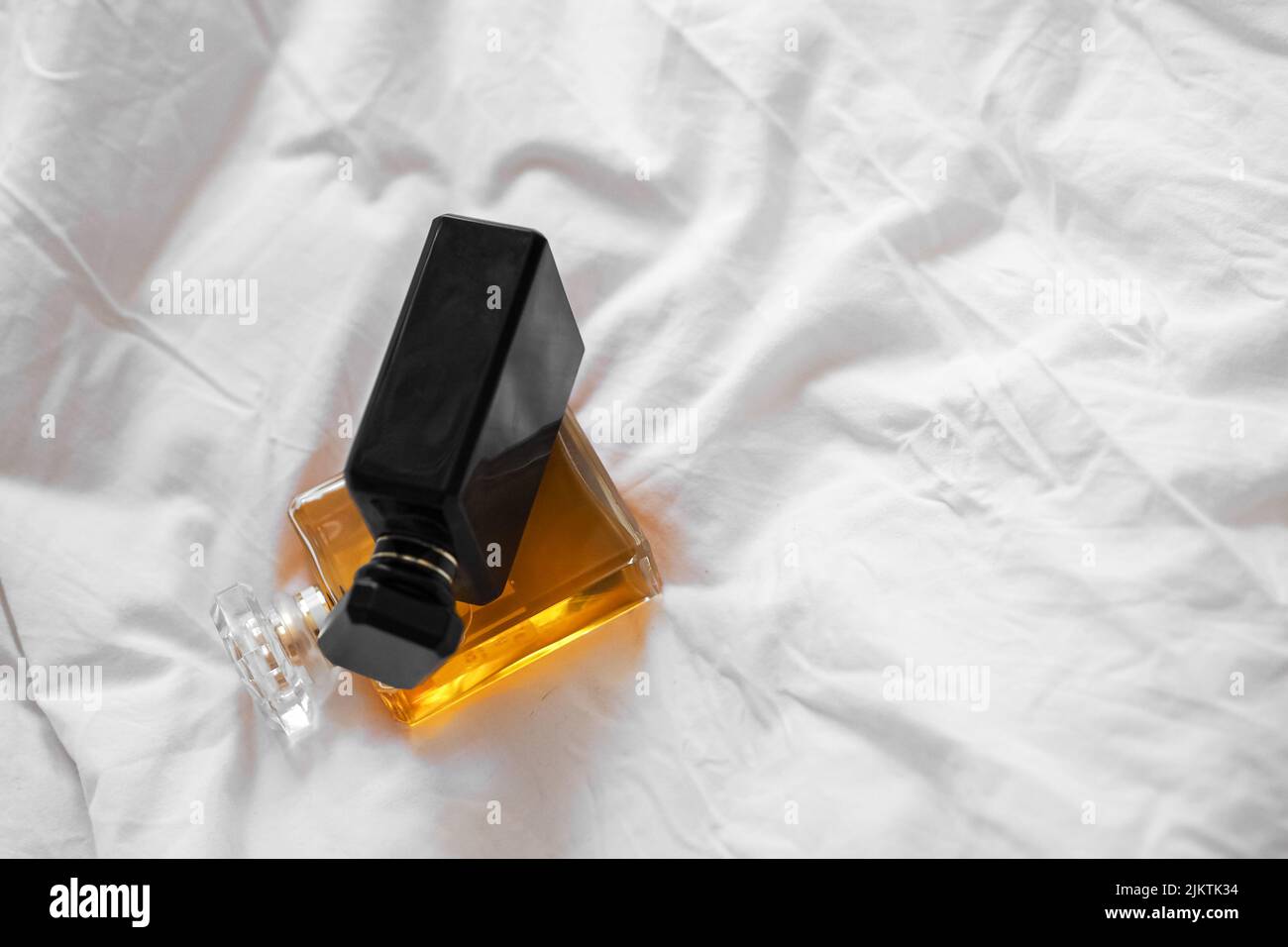 A top view of two perfume bottles on a white bedsheet Stock Photo Alamy