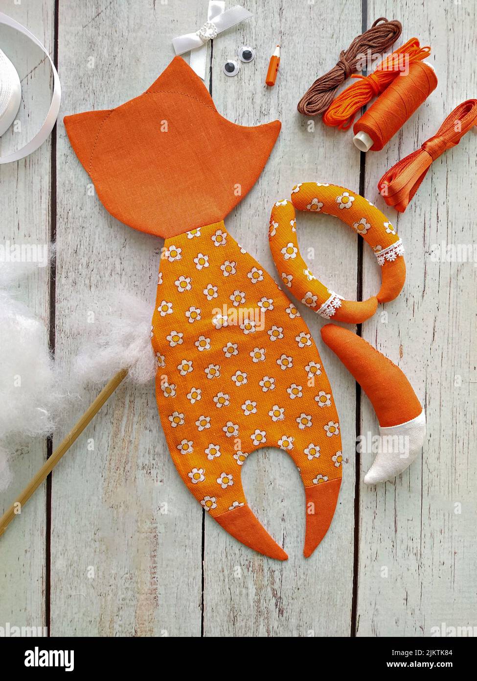 Process of stuffing soft toy red textile fox by handmade, top view and