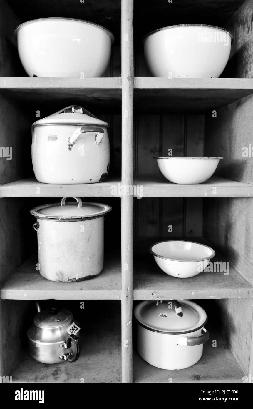 Kitchen shelves with pots and bowls Stock Photo