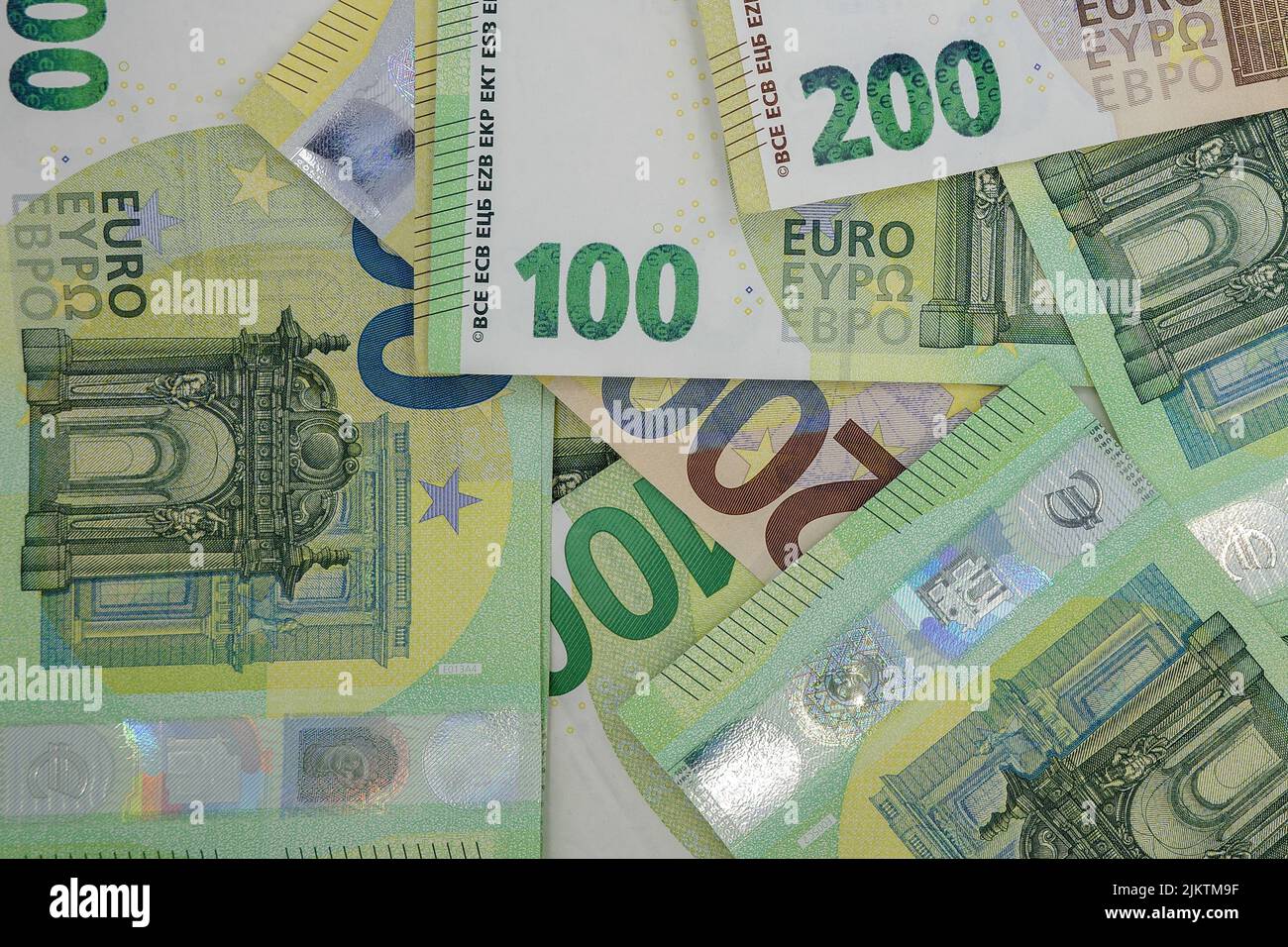 A top view of a pile of 200 and 100 Euro banknotes bills Stock Photo
