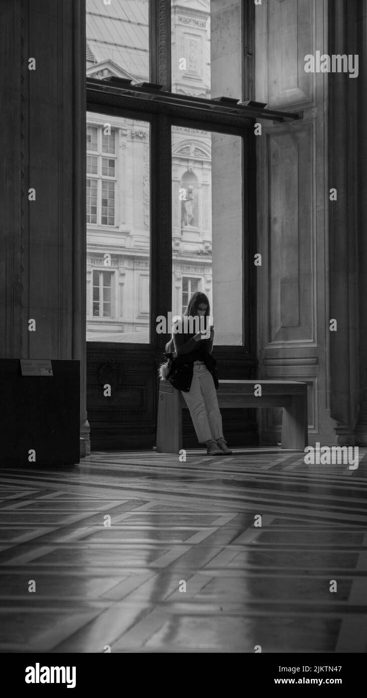 Grayscale photo of man standing near window photo – Free Cloud