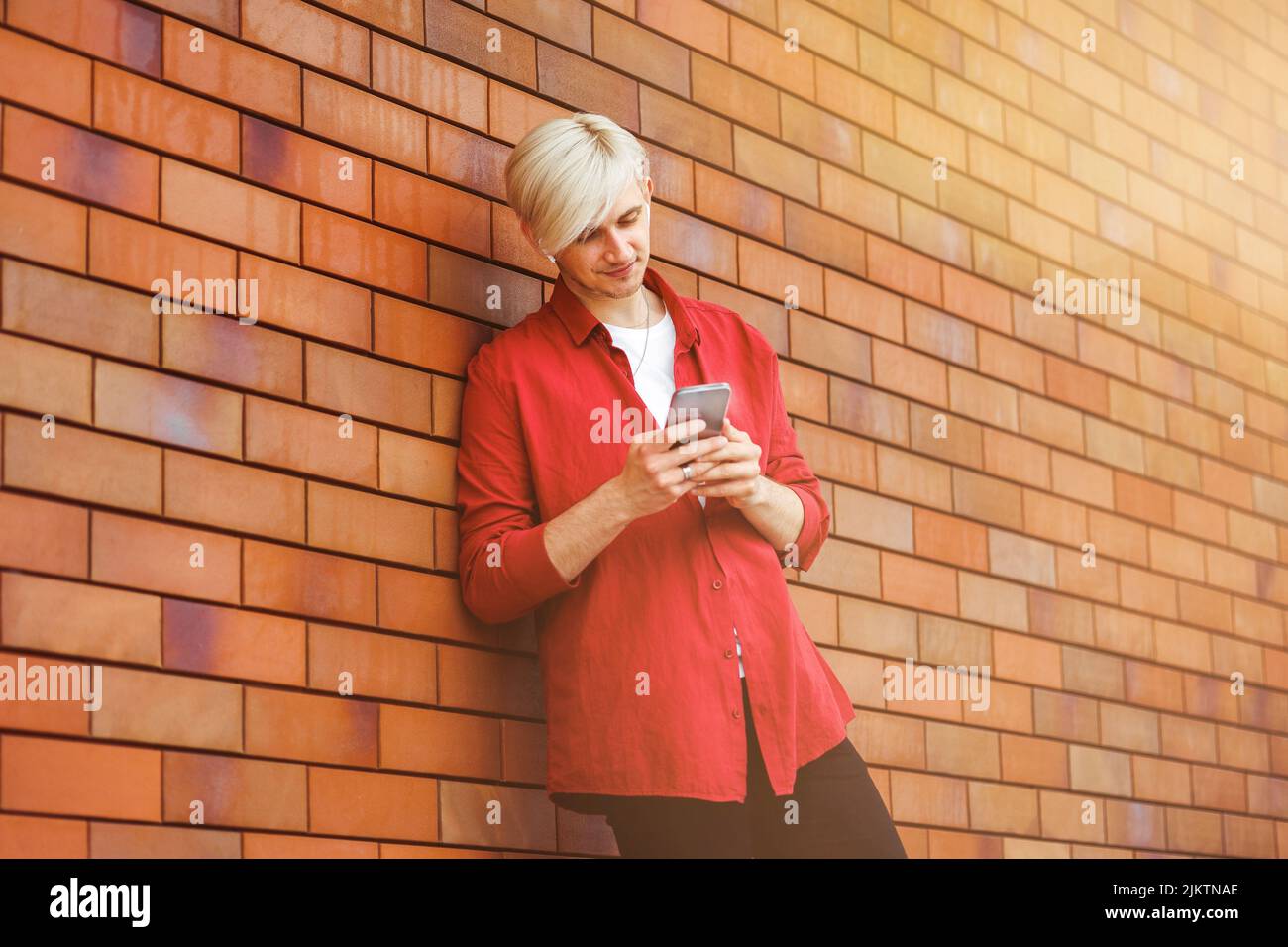 Young guy looking at his smart phone. Stock Photo