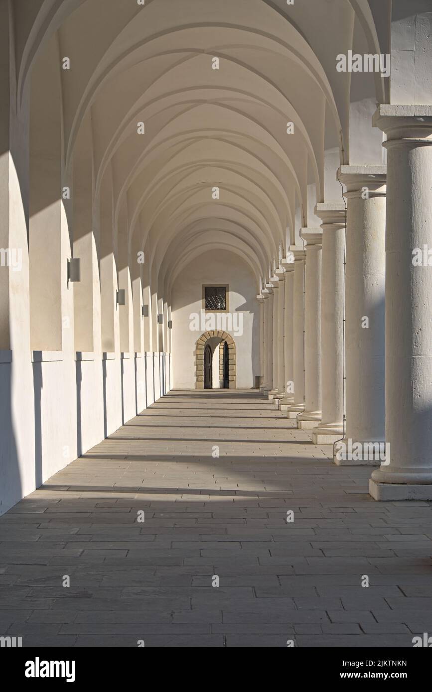 Light shines in white renaissance arcades and throws shades Stock Photo ...
