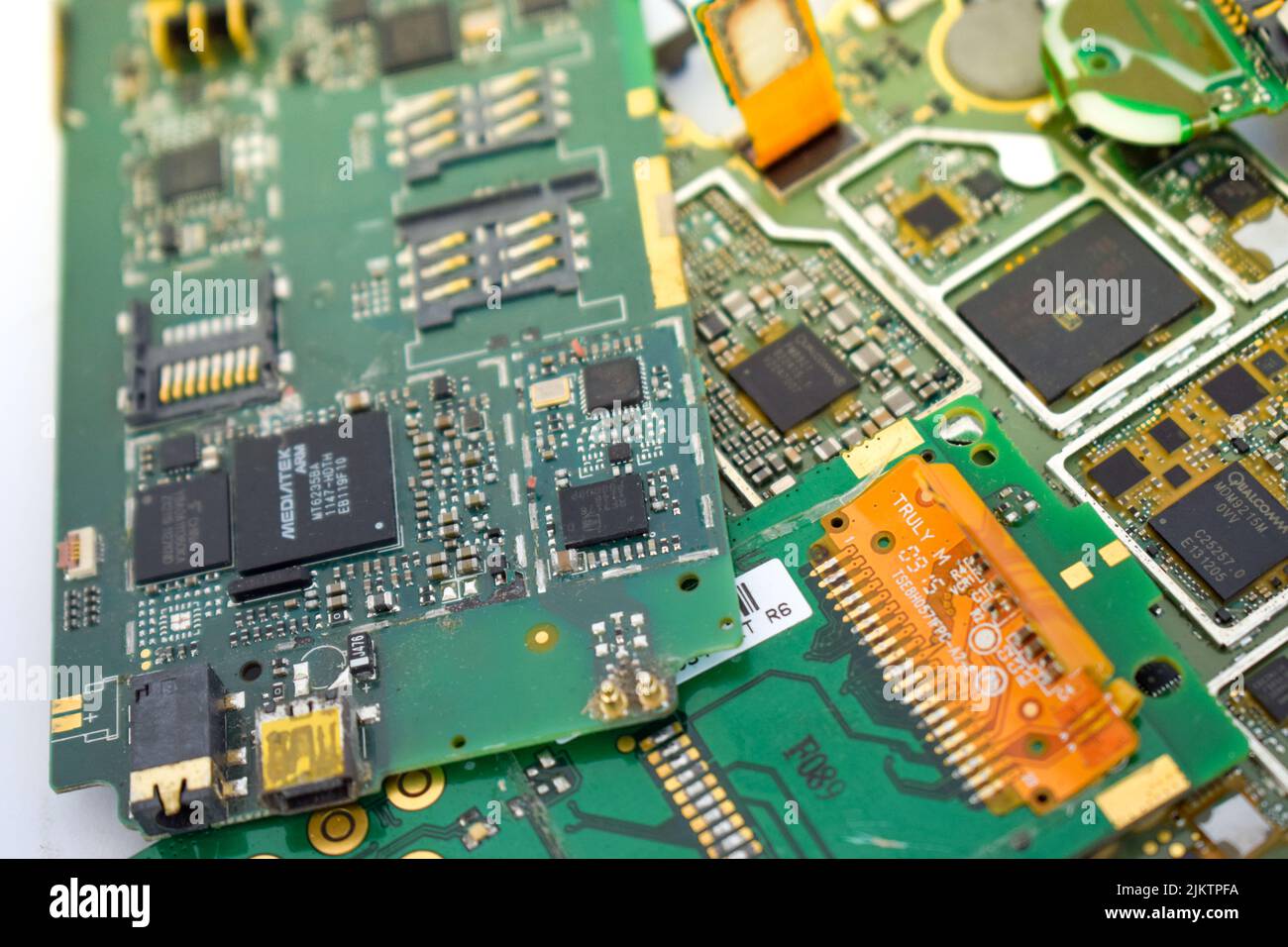 A closeup of a mobile phone mainboard containing gold Stock Photo