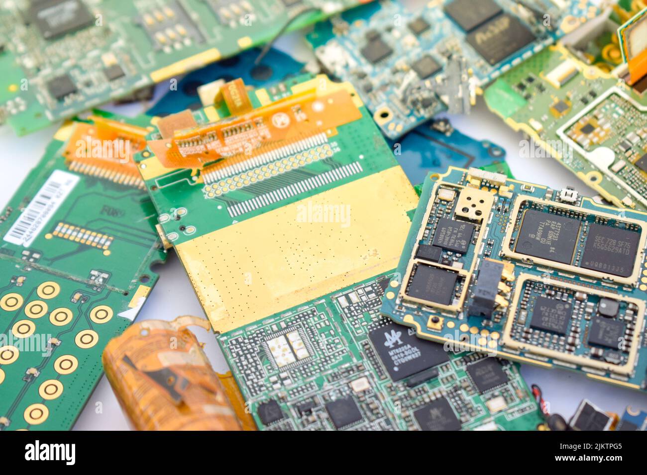 A closeup of a mobile phone mainboard containing gold Stock Photo