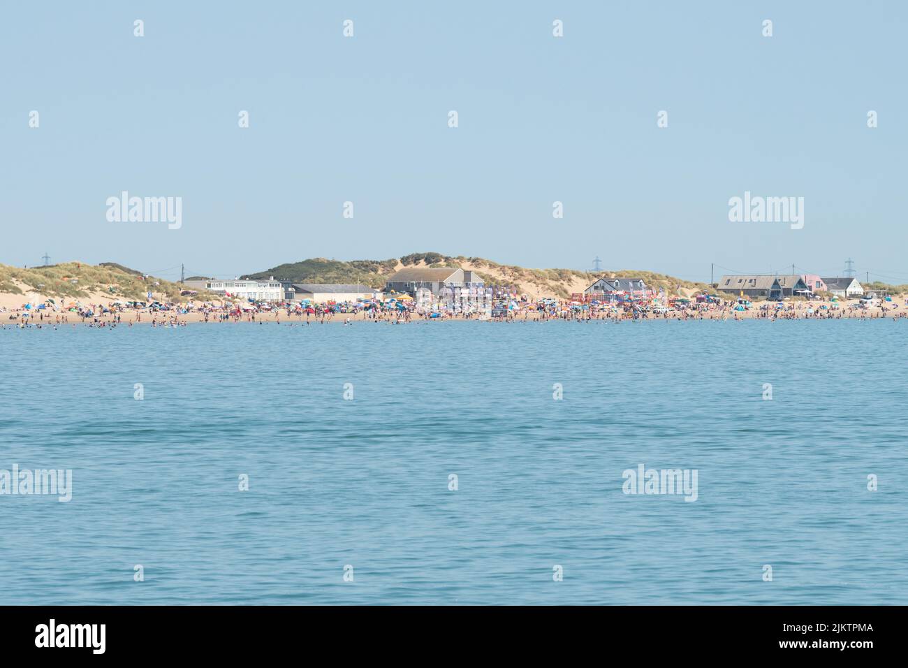 Camber Sands on hot summer day seen from Rye Harbour - East Sussex, England, UK Stock Photo