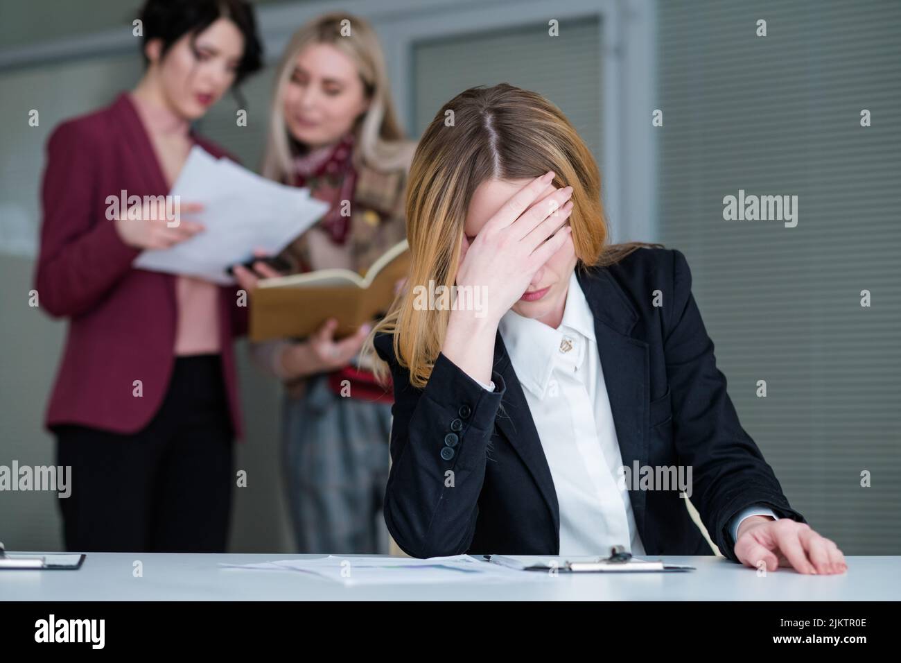 office buzz woman headache noisy workspace Stock Photo