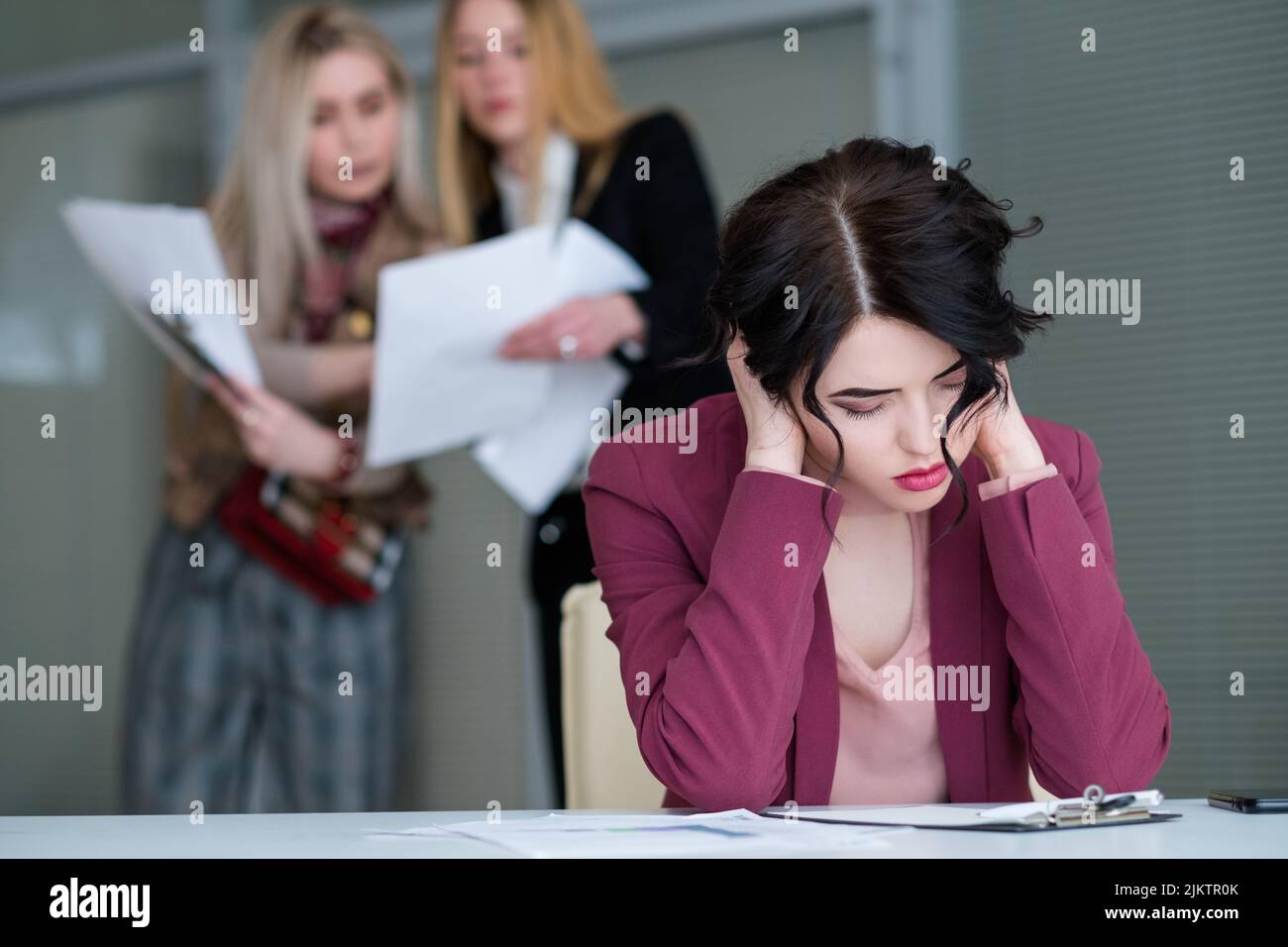 office buzz woman tired noisy workspace Stock Photo