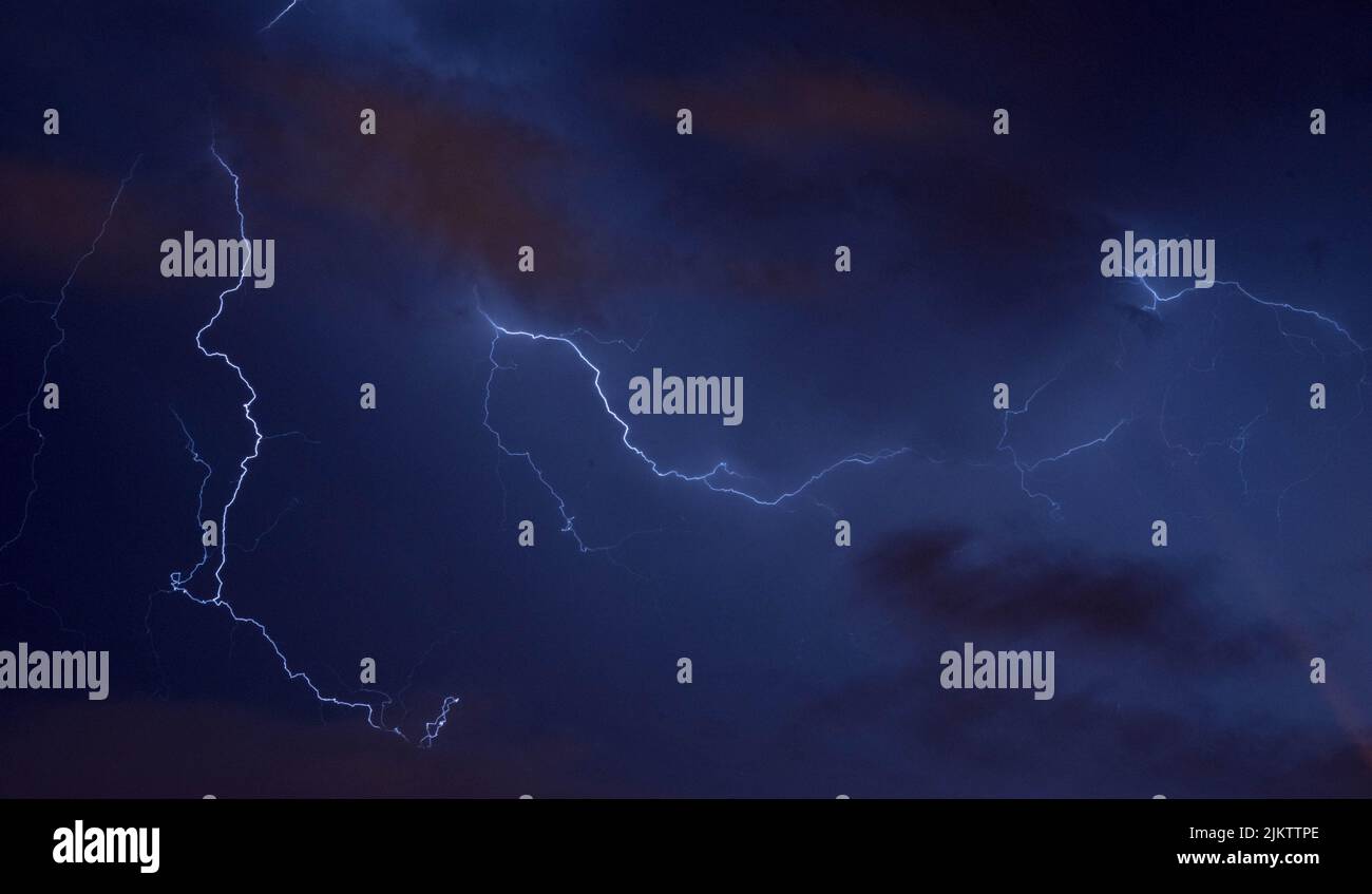 A dramatic view of lightning in the dark night sky Stock Photo - Alamy