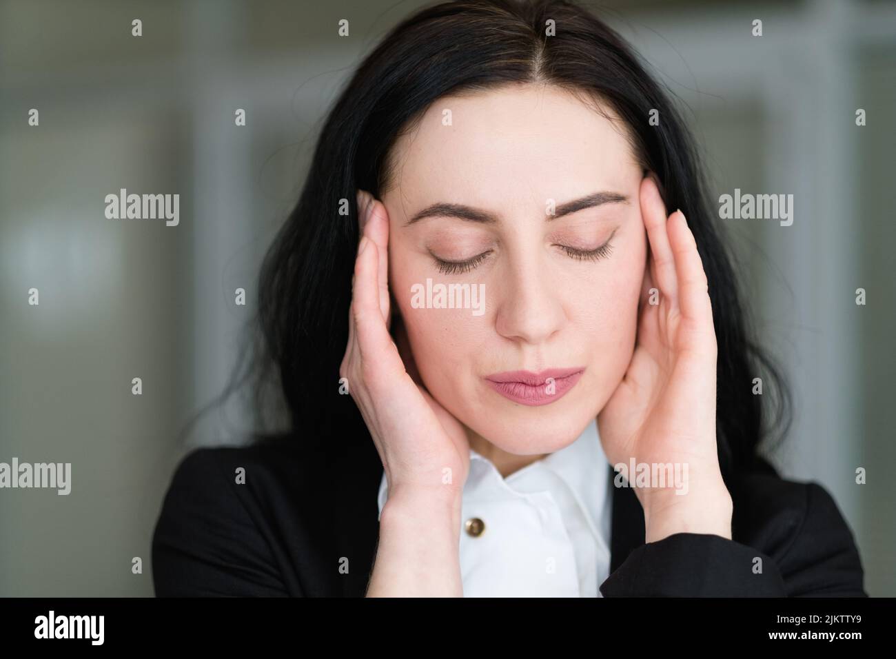 headache stress tiredness woman massaging temples Stock Photo