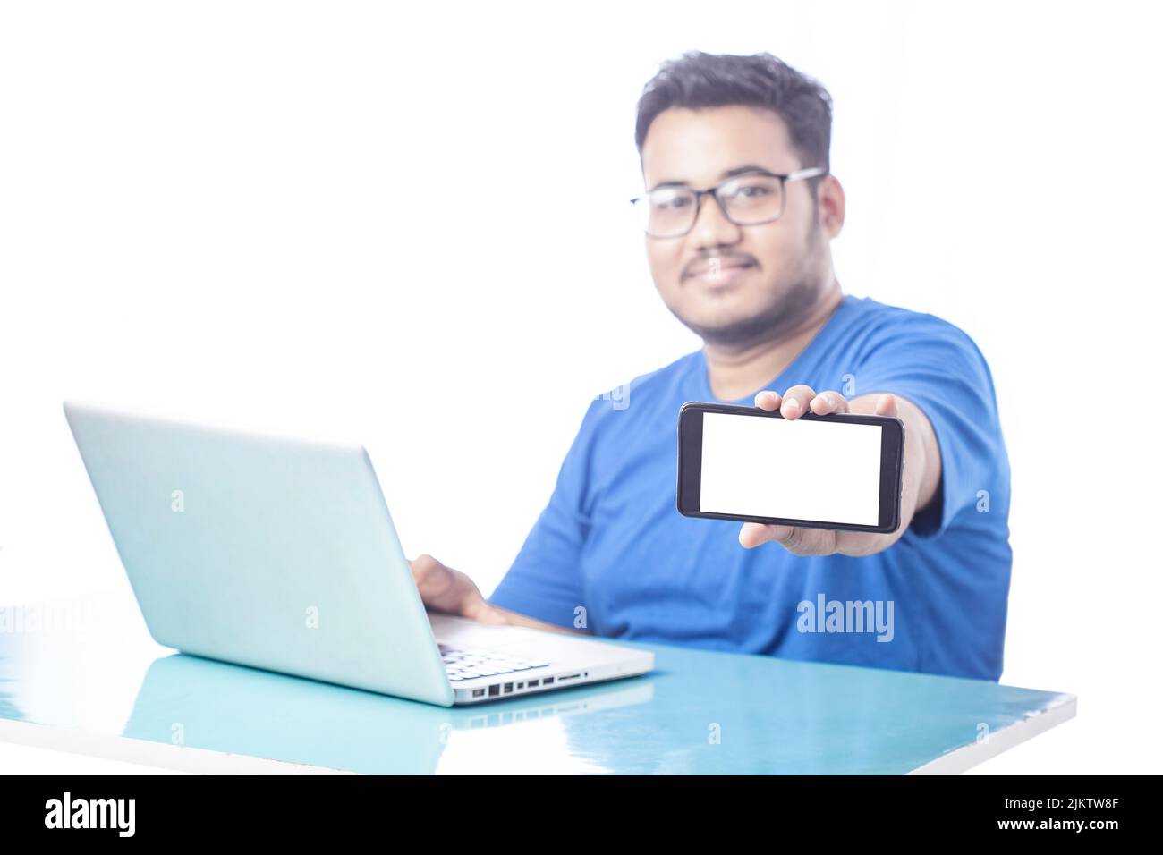 blurred man showing blank mobile phone screen with smile expression Stock Photo