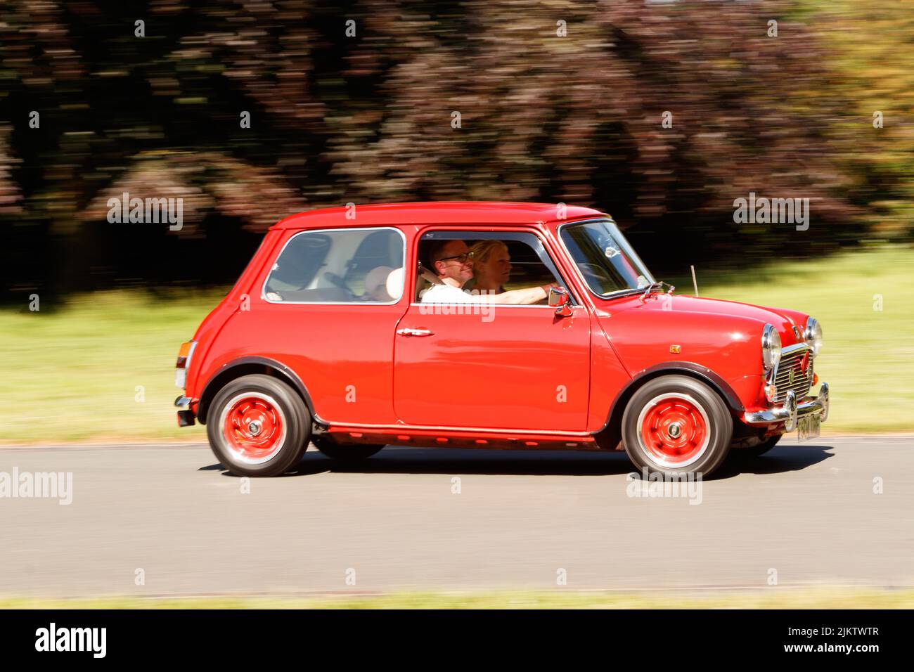 panning speed classic vintage orange red austin mini at weston park classic car show Stock Photo