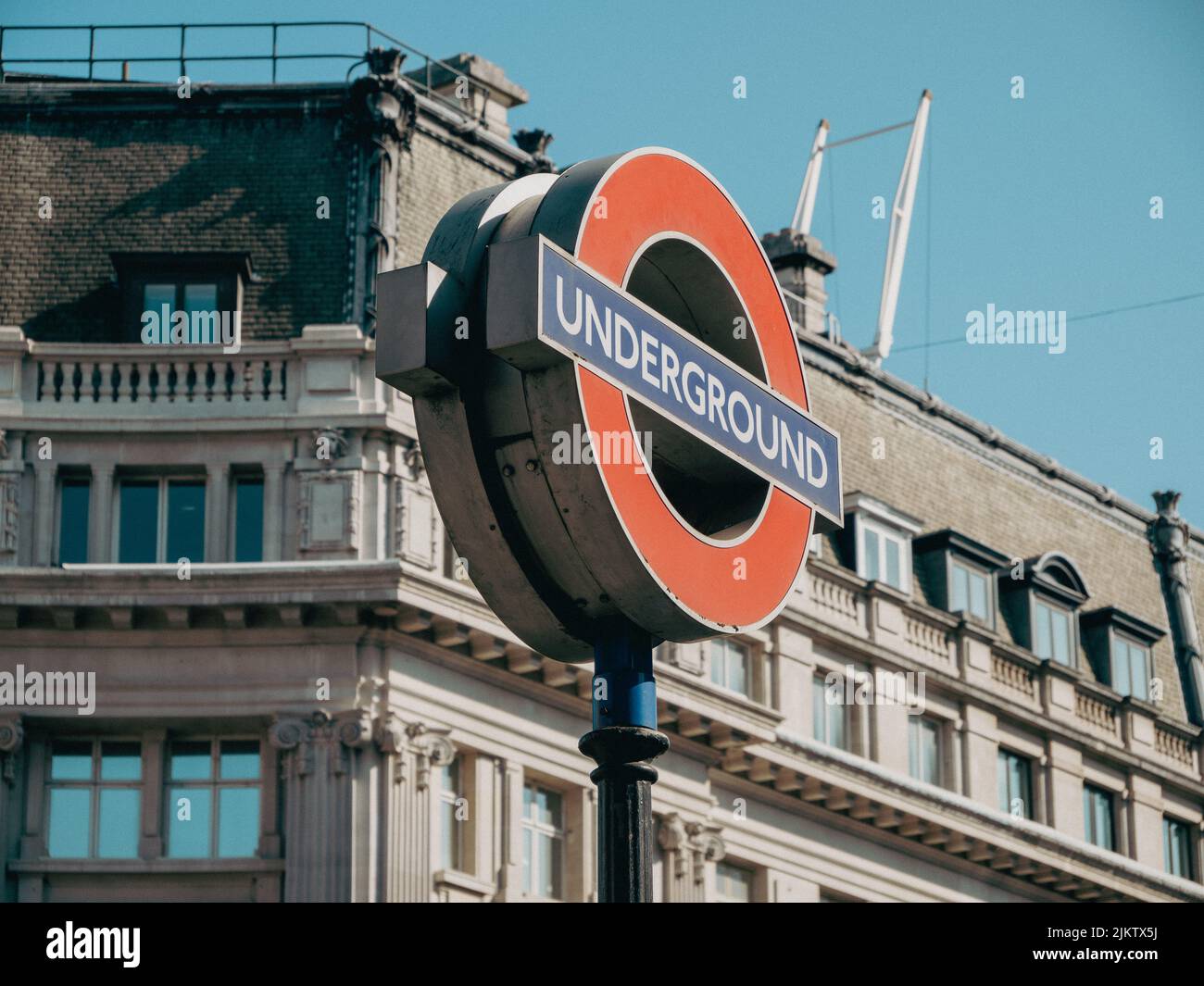 A traditional London Underground sign on the background of old buildings in Oxford Circus station Stock Photo
