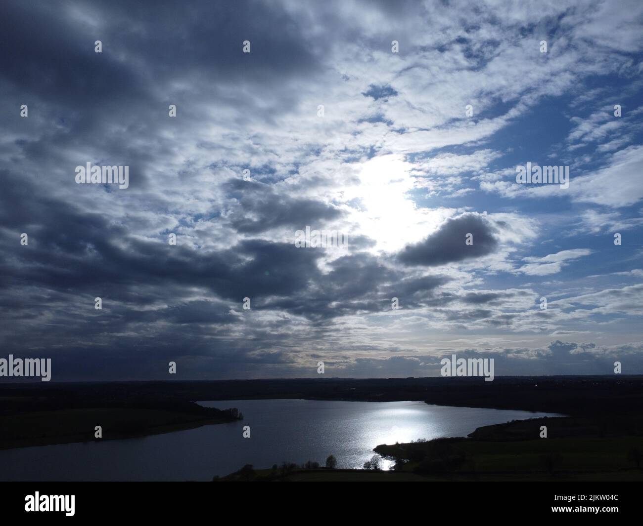 A beautiful landscape view of the lake and green meadows under blue