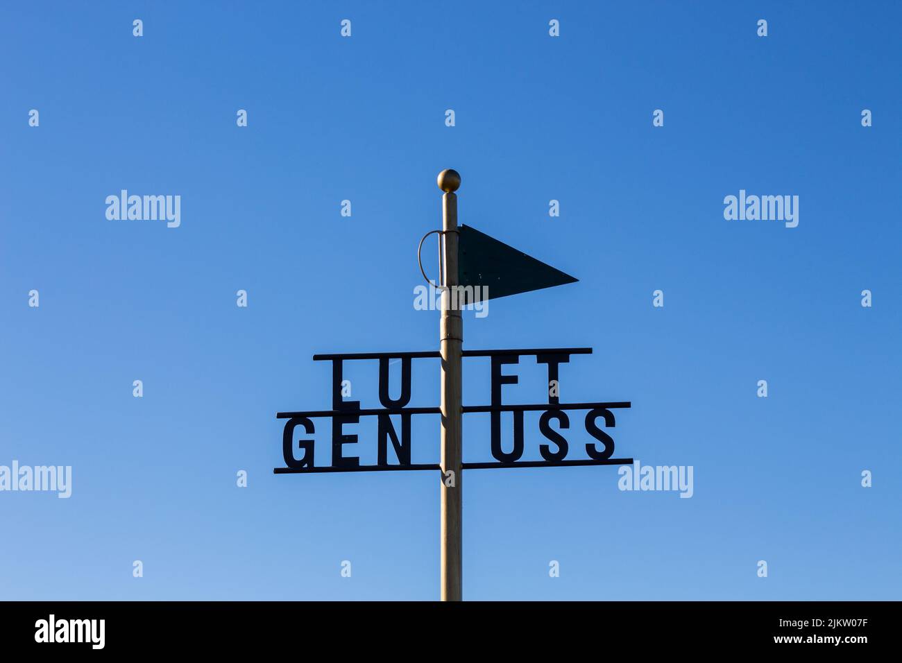 A sign with LUFT GENUSS words on in a greenfield Stock Photo