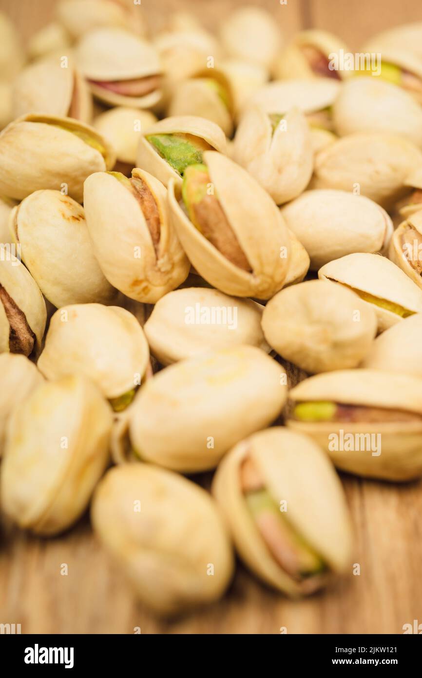 Pistachios or pistachio nuts are small, green, edible nuts Stock Photo