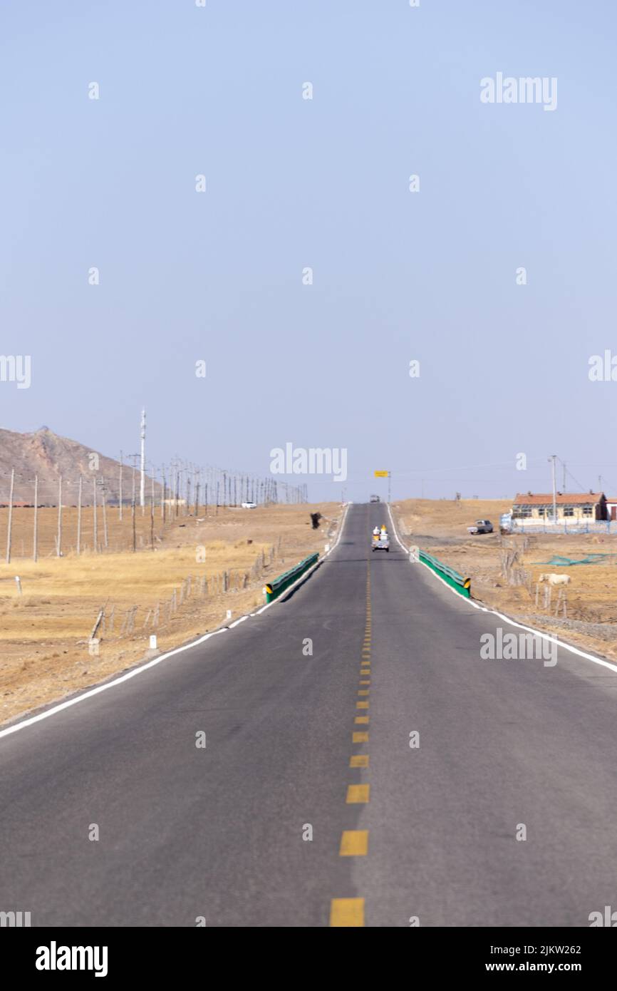 A vertical shot of a road through rocky mountains Stock Photo - Alamy