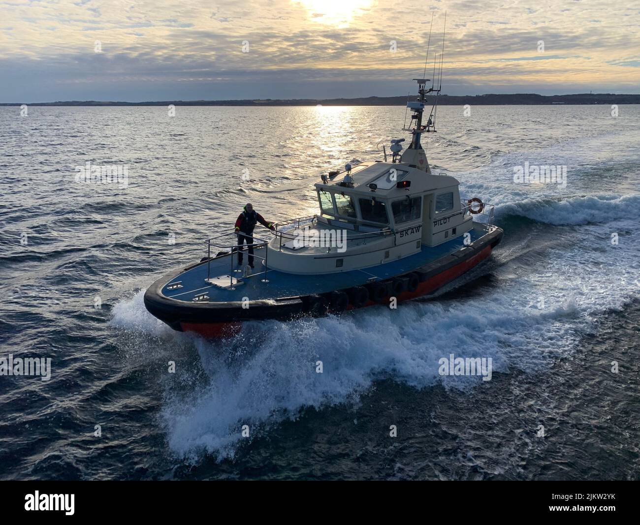 A pilot boat approaching to a big vessel in the sea Stock Photo Alamy