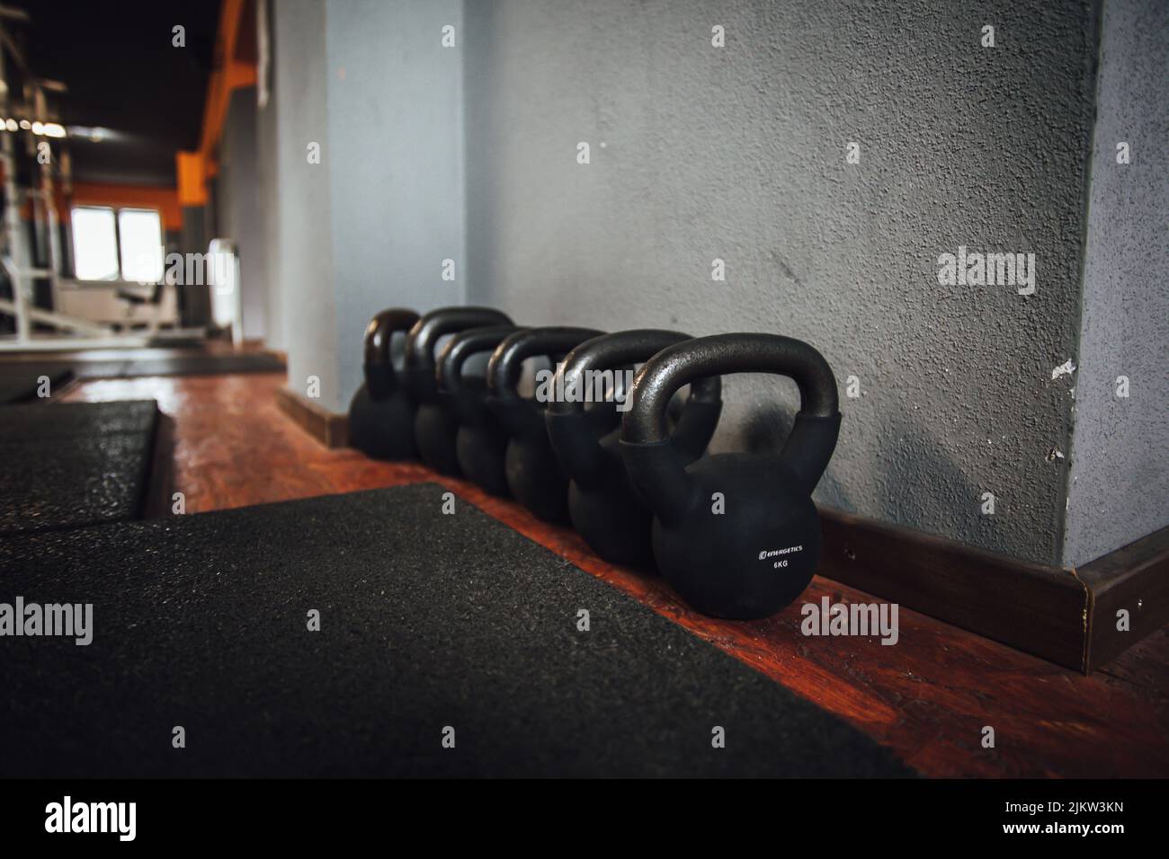 A beautiful shot of a line of black dumbbells in body-building gym Stock Photo