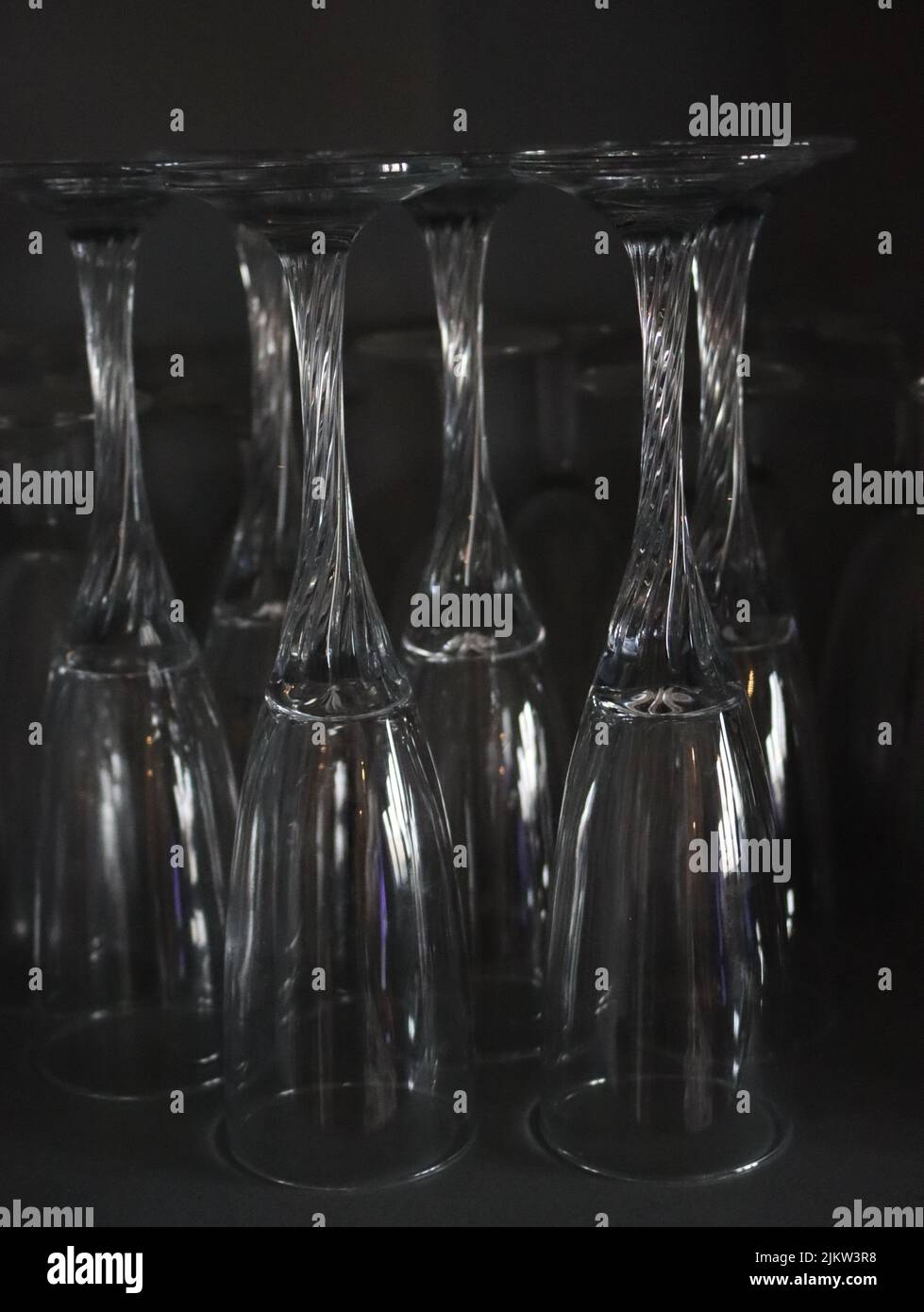A vertical closeup of a set of glasses placed upside down Stock Photo