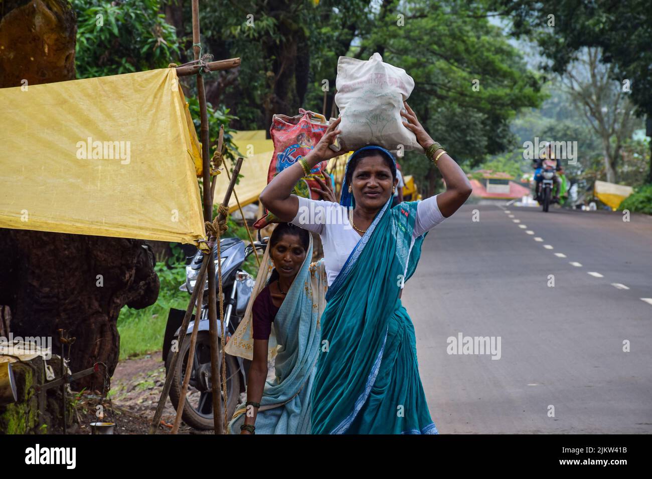 Kolhapur ,India- September 15th 2019; stock photo of 50 to 60 age group Indian women wearing saree buying groceries from street vendor in village week Stock Photo