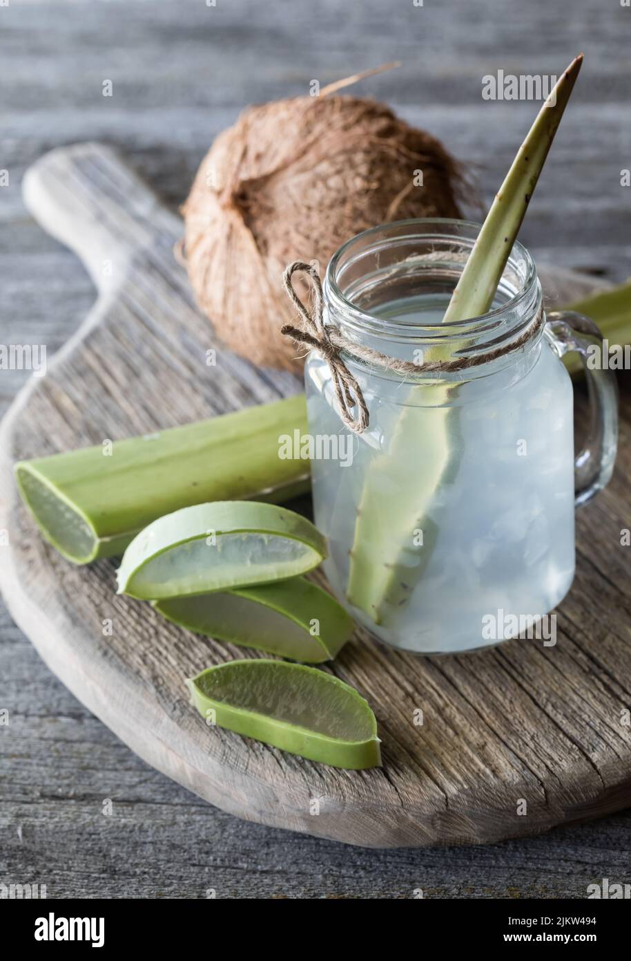 Coconut water with aloe vera mixed in, surrounded by pieces of aloe