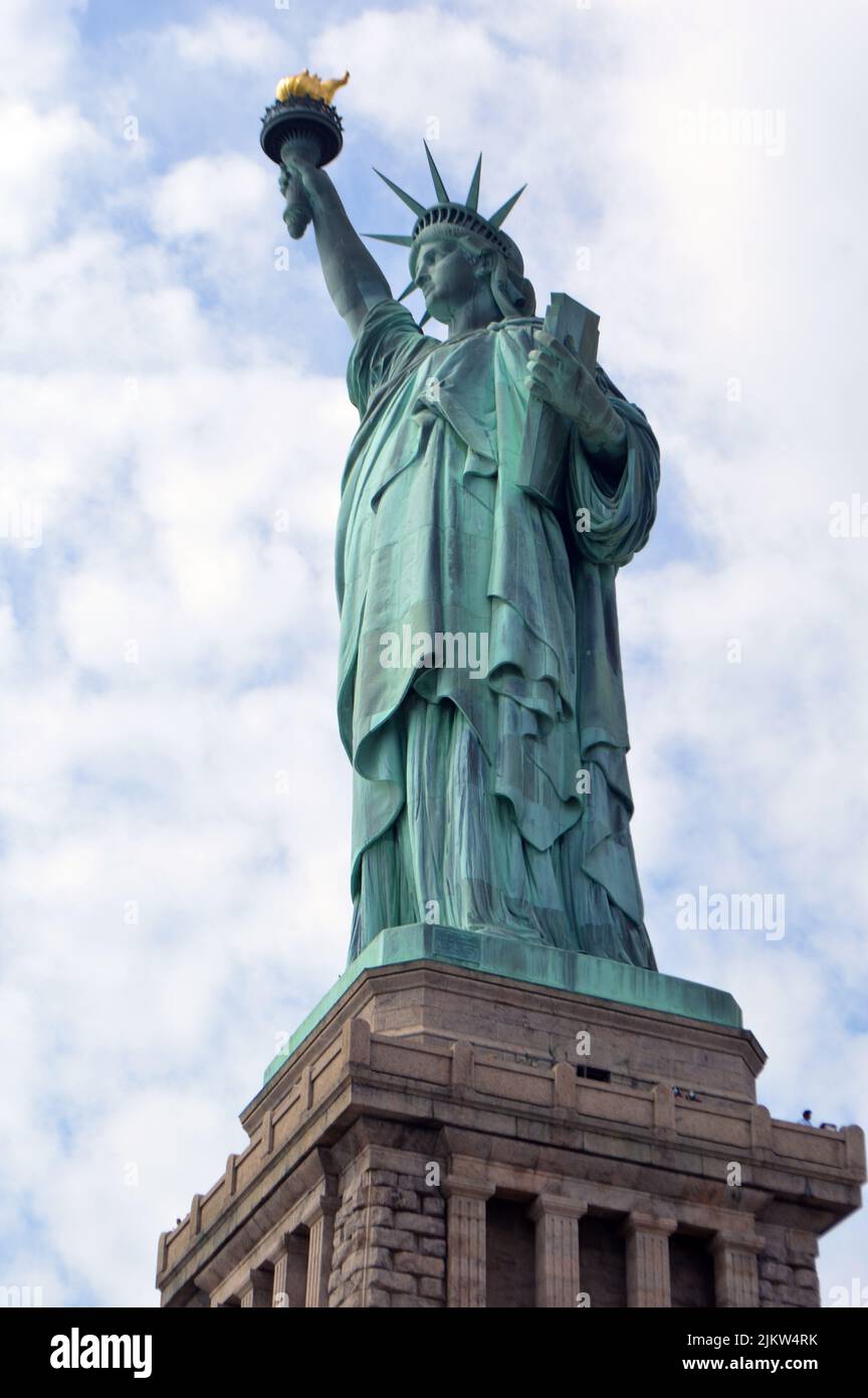 A vertical shot of the Statue of Liberty in New York City, in the ...