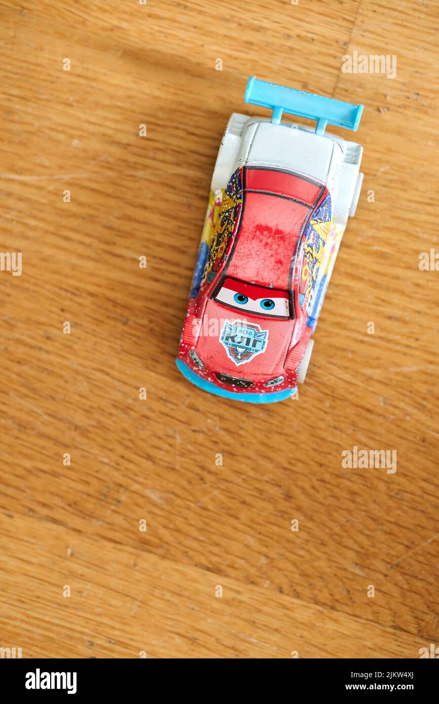 The Mattel Disney Pixar toy model car from the Cars movie on a wooden surface Stock Photo