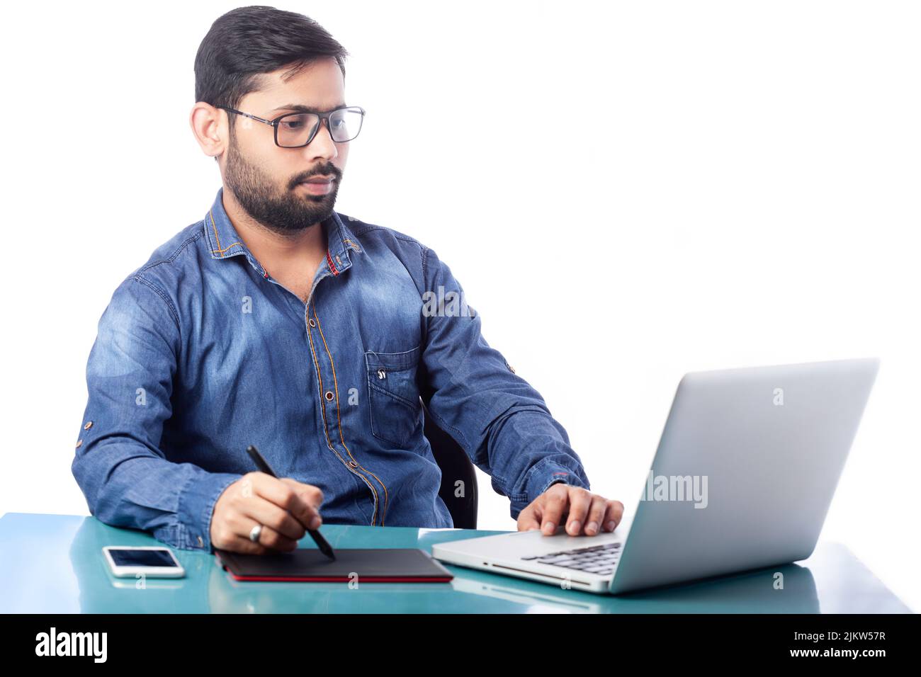 young graphic designer using stylus pen and digital tablet for drawing and editing in white background Stock Photo