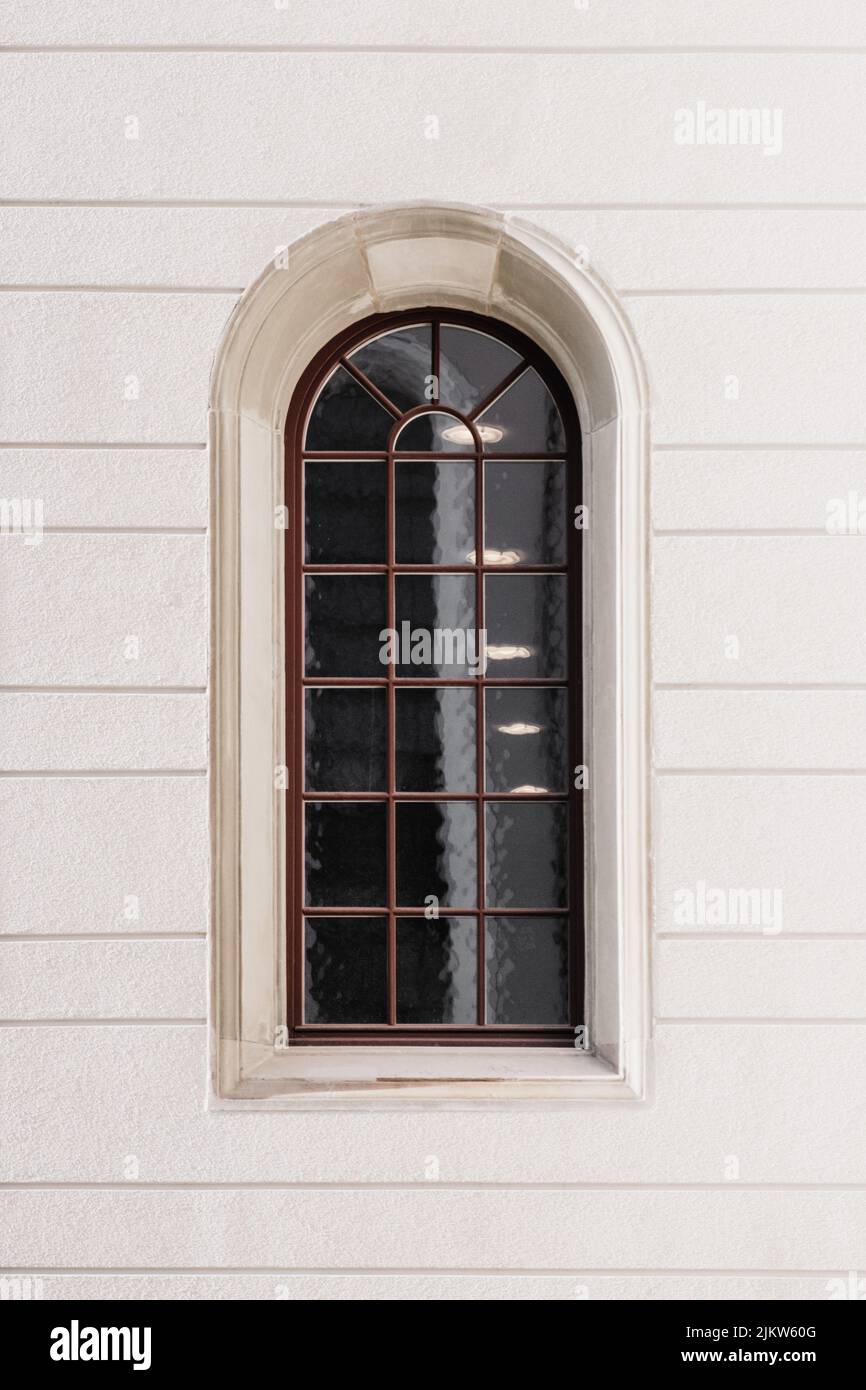A vertical shot of a window on a white stone building in St.Gallen, Switzerland Stock Photo