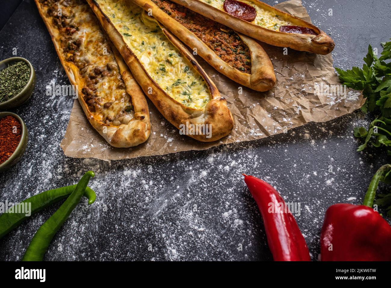 A closeup of four fresh homemade pide with cheese and meat Stock Photo
