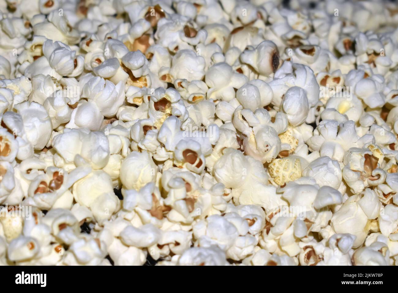 Popcorn in a plastic bag as a background. Close-up Stock Photo