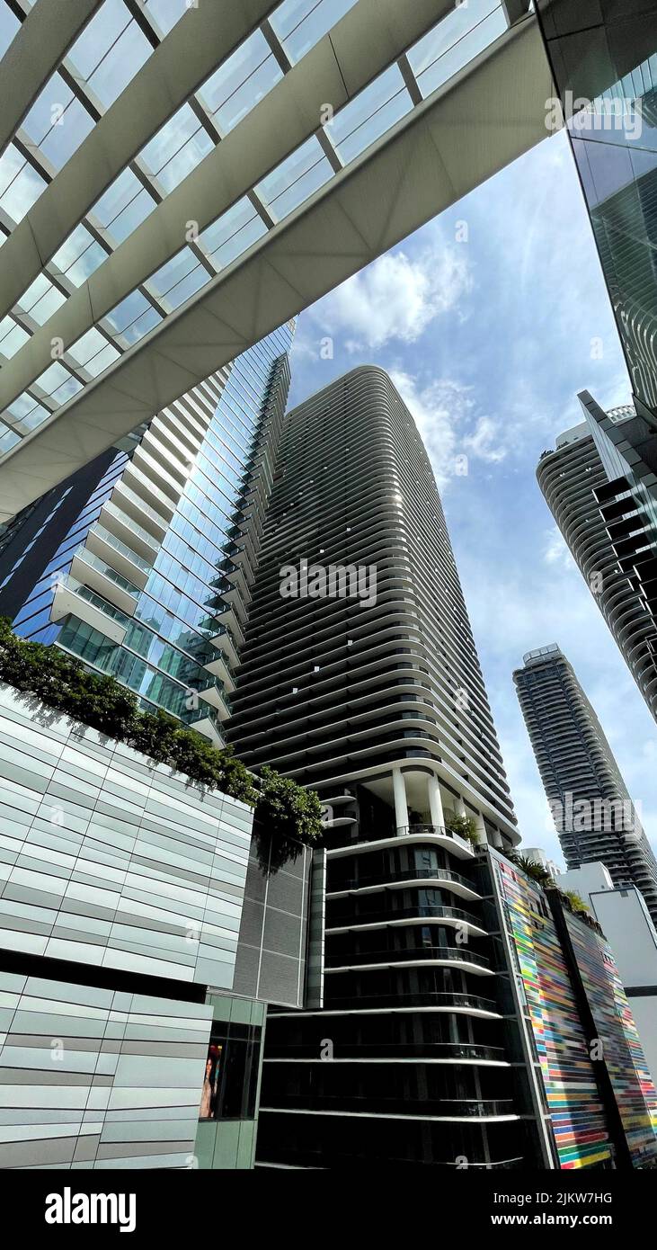 A vertical low angle shot of futuristic glass buildings Stock Photo