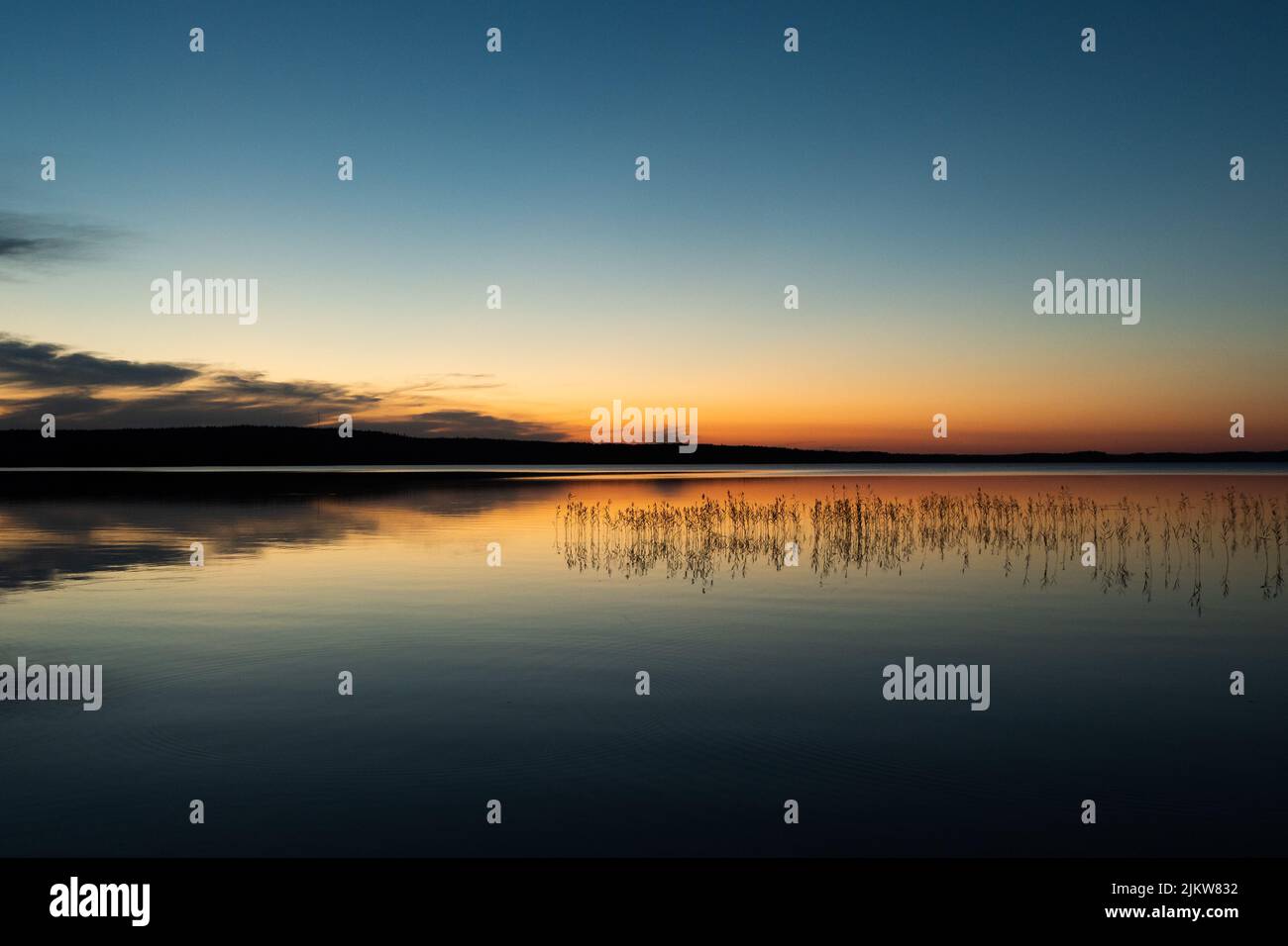 Reflections of the sunset on the lake surface Stock Photo - Alamy