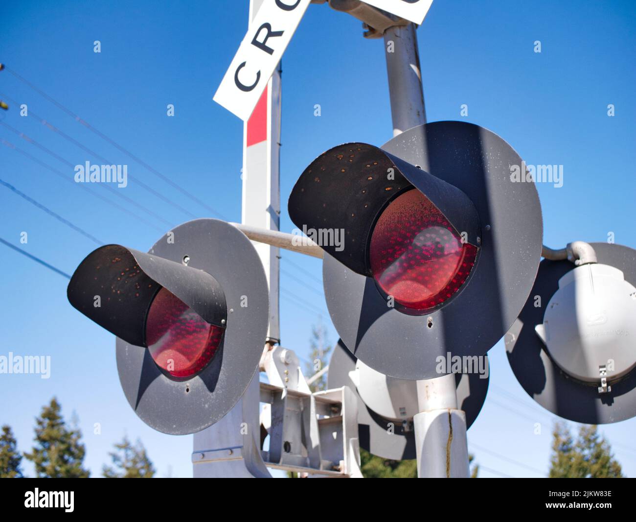 A closeup shot of railroad crossing lights in Turlock, California, USA against a clear sky Stock Photo