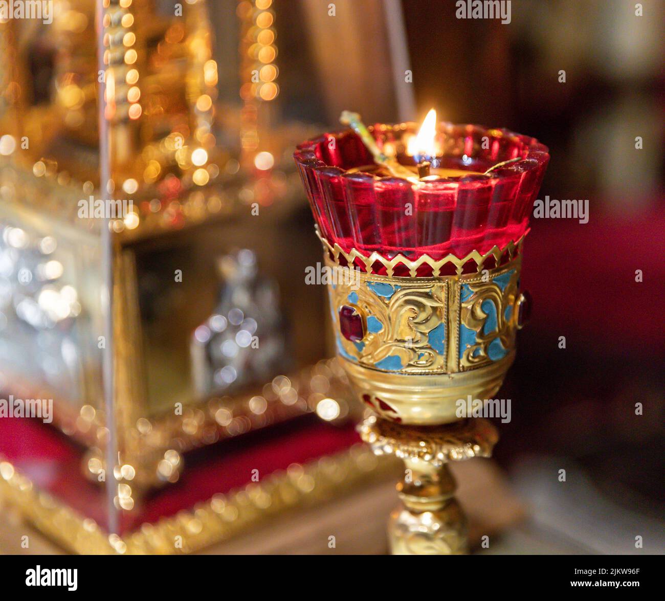 A selective focus shot of a lit candle in the eastern orthodox church altar Stock Photo