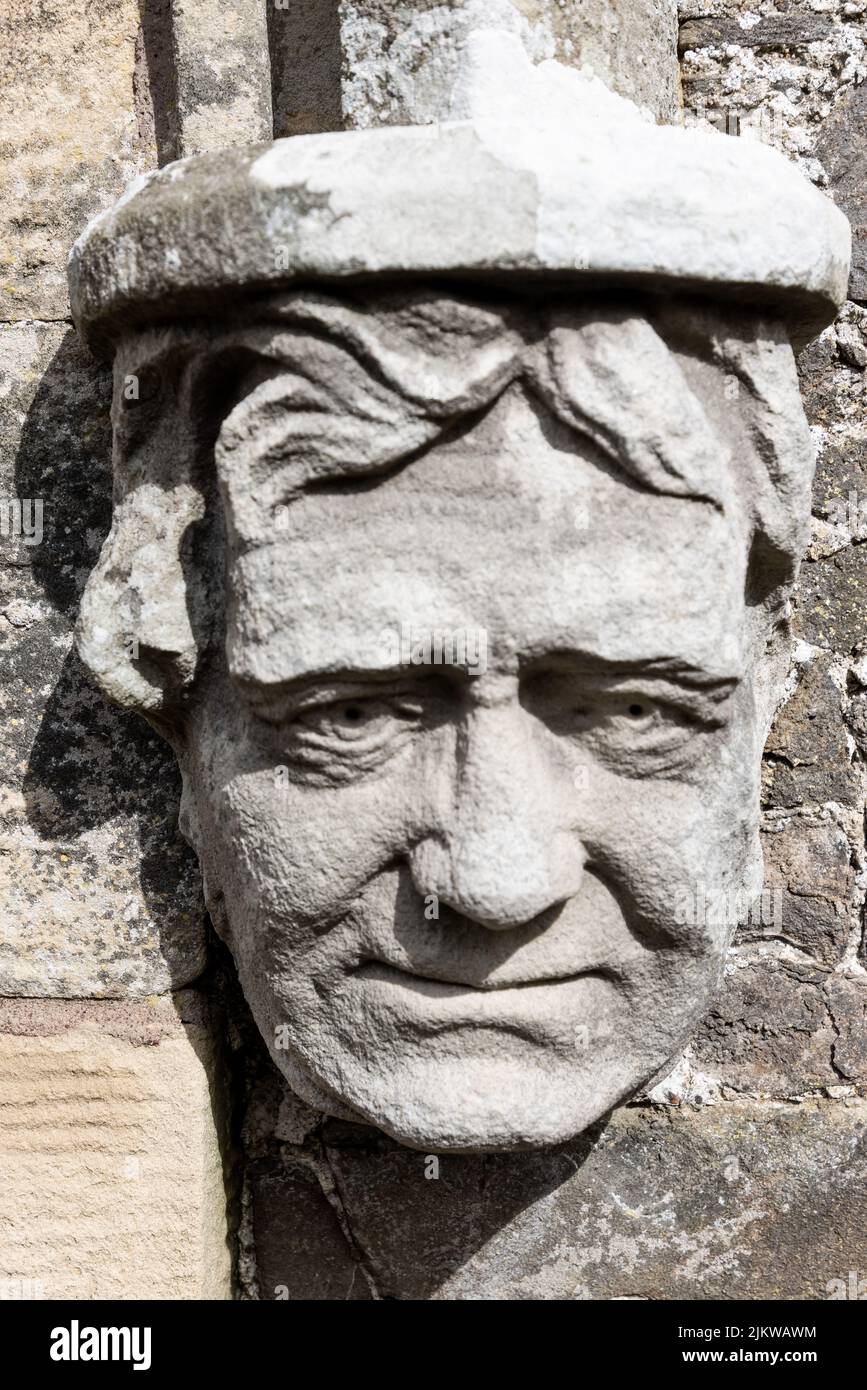 A detailed stone carving of man's face on country house Stock Photo