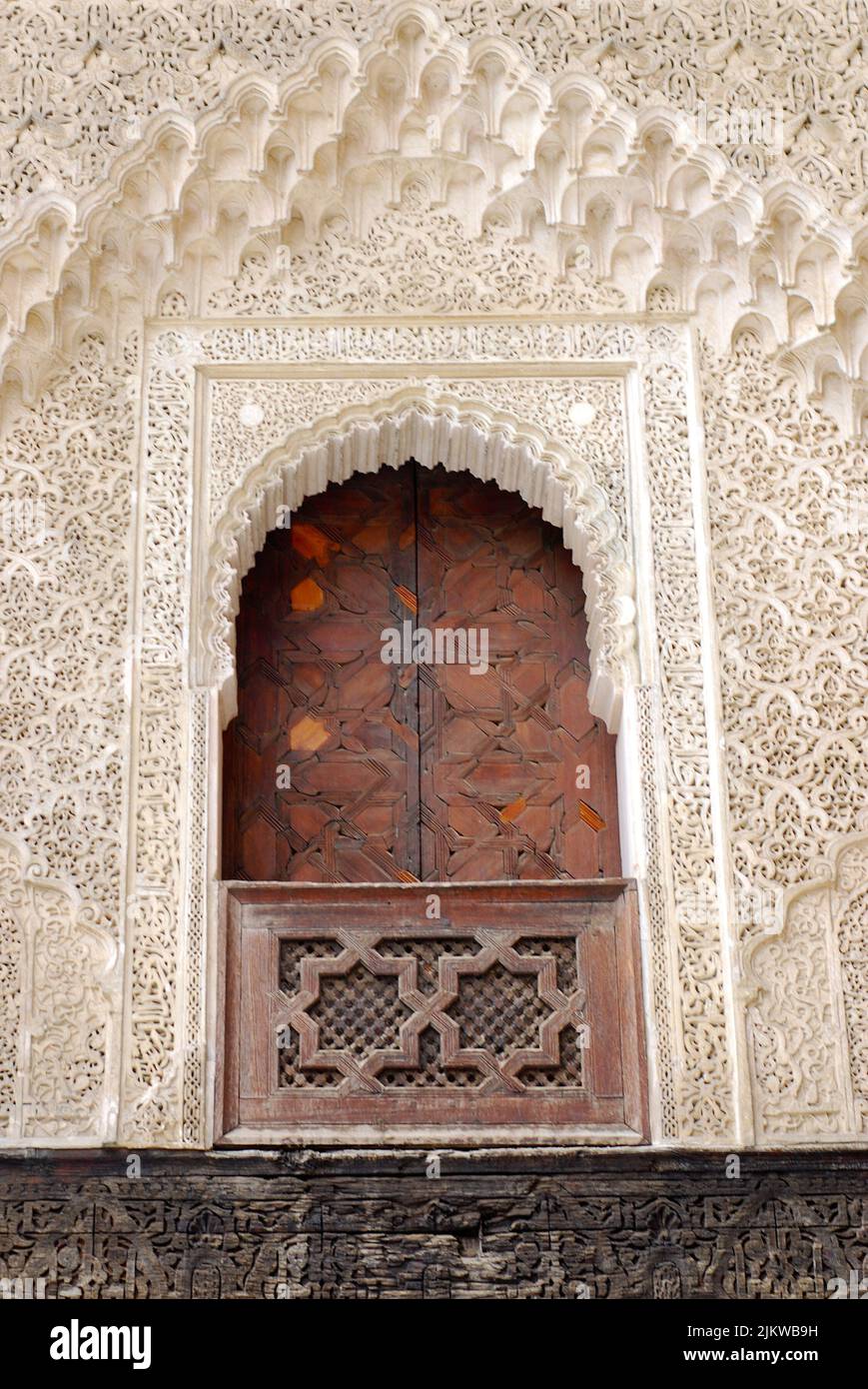 Wooden carved window with shutters and carved arch in Marrakech Morocco ...