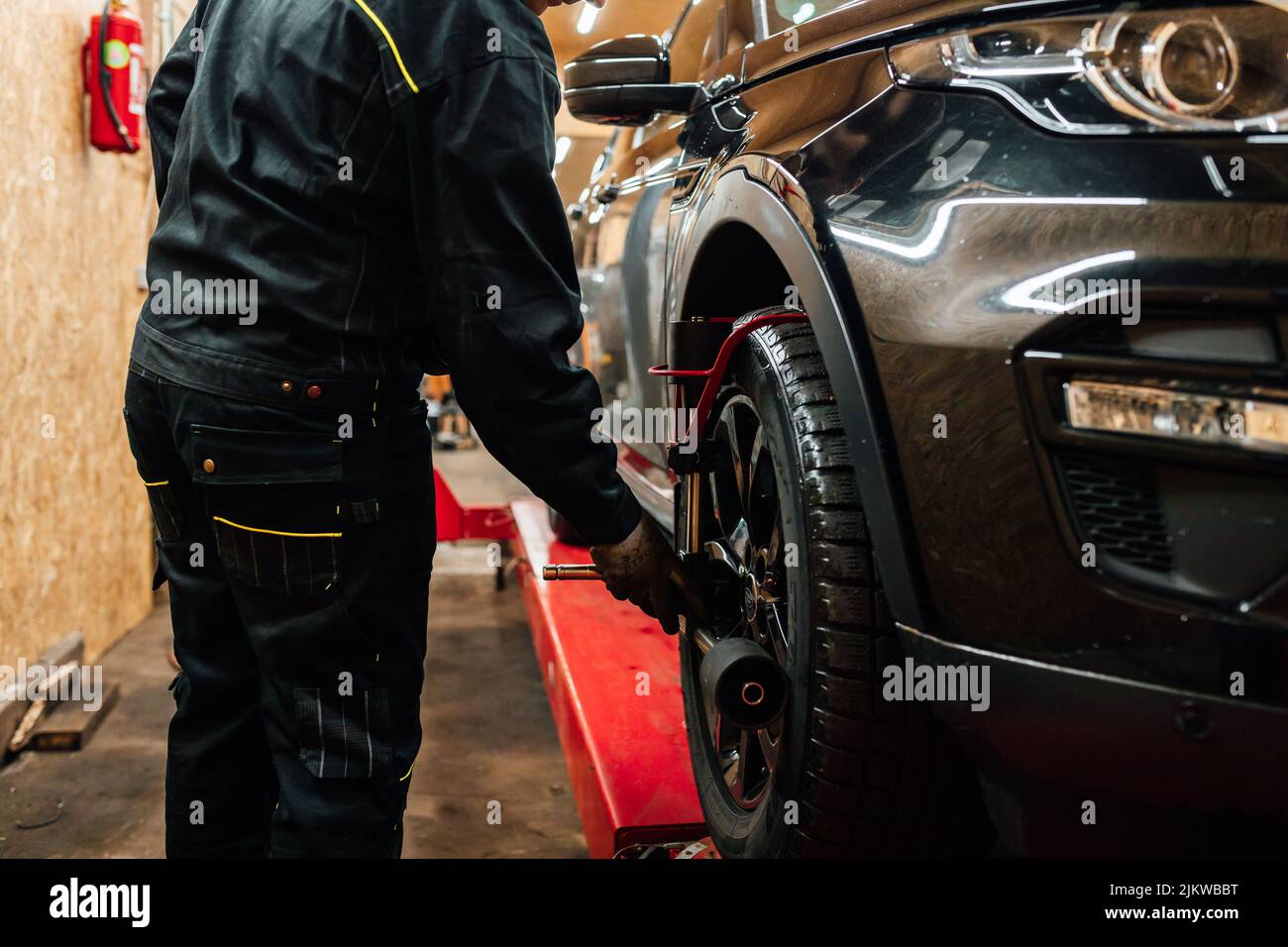 A car mechanic installing wheel alignment sensors Stock Photo Alamy